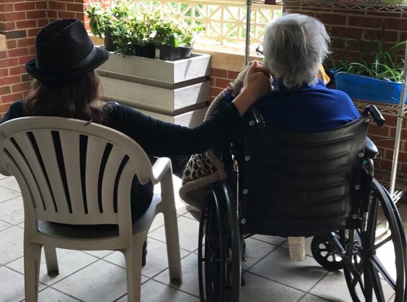 JoAnne Klimovich Harrop (right) holding Evelyn Klimovich's hand. (Photo courtesy of Carol Danhires)